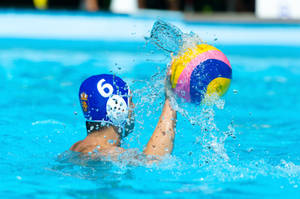 Competitive Underwater View Of A Water Polo Athlete In Action Wallpaper