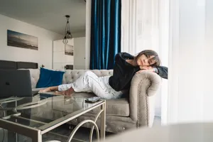 Complacent Girl Relaxing On Couch Wallpaper
