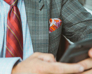 Confident Man Wearing A Checkered Suit Wallpaper