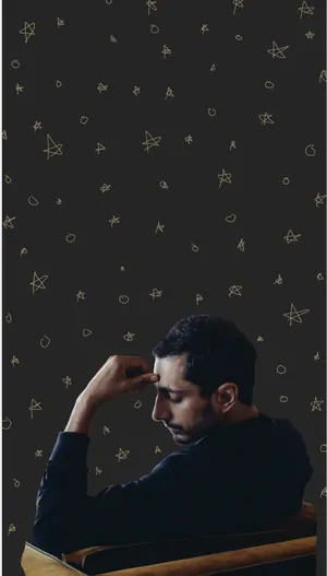 Contemplative_ Man_ Against_ Star_ Pattern_ Background Wallpaper