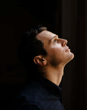 Contemplative Man Looking Upward Wallpaper