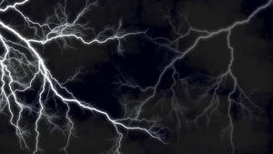 Contrasting Beauty - A Bolt Of Lightning Striking Through The Night Sky Wallpaper