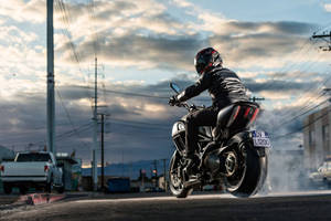 Cool Bike Rider On An Empty Street Wallpaper