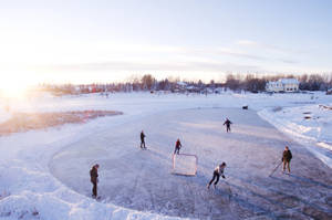 Cool Hockey Players Skate Through The Ice Wallpaper