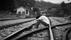 Cool Sad Boy On Train Tracks Wallpaper
