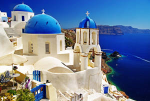 Country Summer In Santorini - Blue Roofs Contrasting With Golden Sunlight Wallpaper