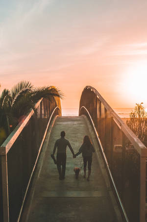 Couple Crossing A Bridge Wallpaper