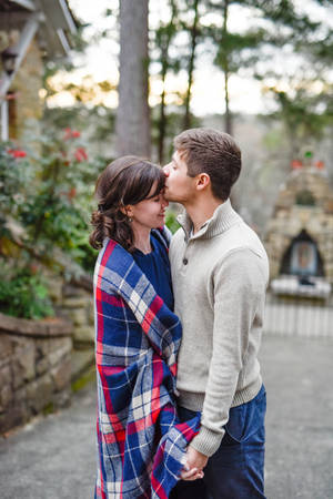 Couple Forehead Kiss In Garden Wallpaper