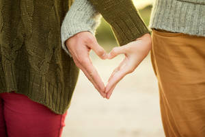 Couple Forming A Heart Wallpaper