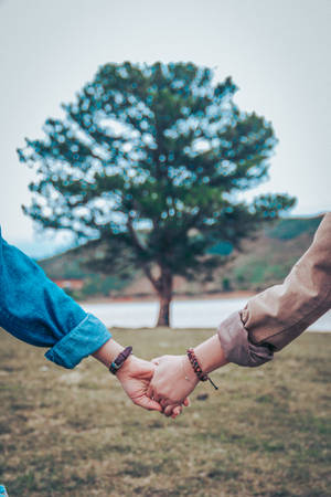 Couple Holding Hands Outdoor Wallpaper