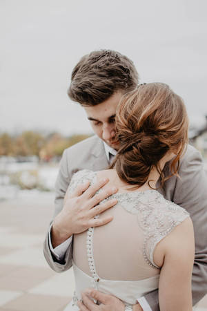 Couple Hugging Bride And Groom Wallpaper