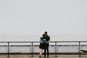 Couple Hugging Side By Side Wallpaper