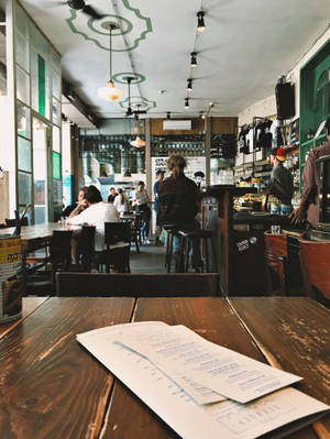 Cozy Coffee Shop Menu On Table Wallpaper