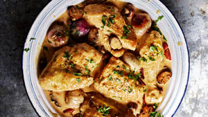 Creamy Coq Au Vin On A White Ceramic Plate Wallpaper