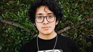 Cuco Wearing Black Shirt Wallpaper