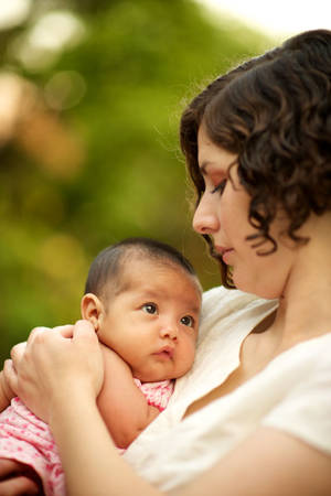 Curly Haired Mother And Cute Baby Wallpaper