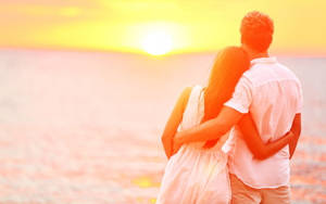 Cute Couple Watching Sunset Wallpaper