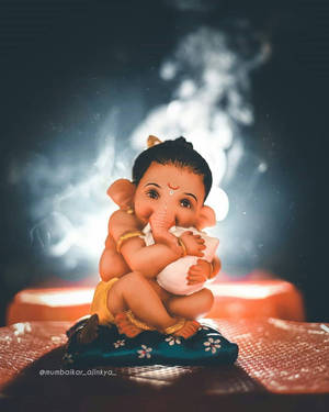 Cute Ganesha Hugging Makhan Wallpaper