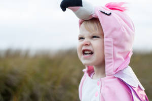 Cute Girl In Pink Flamingo Onesie Wallpaper