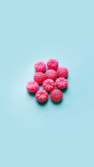 Cute Iphone Teal With Pink Raspberry Candies Wallpaper