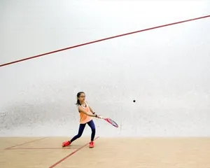 Cute Little Girl Playing Squash Wallpaper