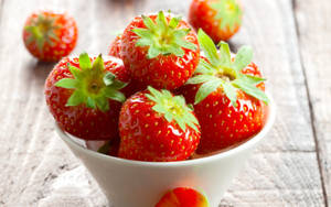 Cute White Bowl Of Strawberries Wallpaper