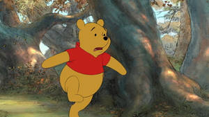 Cute Winnie The Pooh In Forest Wallpaper