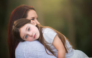 Cute Young Girl With Mother Wallpaper