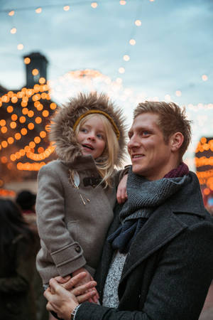 Dad And Daughter Wearing Winter Clothes Wallpaper