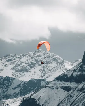 Daredevil Paraglider Soaring Through The Sky Wallpaper