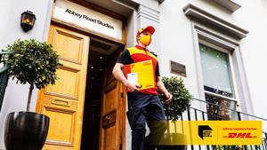 Dedicated Dhl Courier In Action Wallpaper