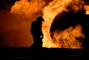 Dejected Fireman In The Middle Of A Fire Wallpaper