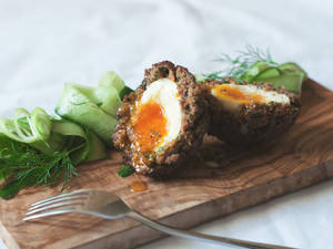 Delectable British Scotch Eggs With Finely Sliced Zucchini Wallpaper