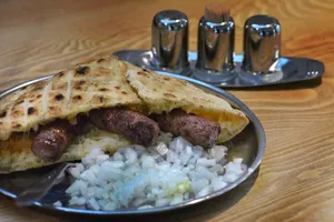 Delectable Ćevapi Tucked Inside Pita Bread Wallpaper