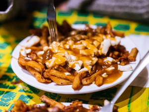 Delectable Forkful Of Poutine Wallpaper