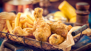 Delectable Sheesh Fried Chicken Served With Crispy Potato Fries Wallpaper