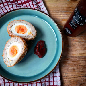 Delectable Traditional British Scotch Egg With Brown Sauce Wallpaper