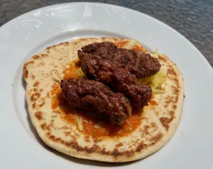 Delicious Ćevapi Sausages Served On Fluffy Pita Bread Wallpaper