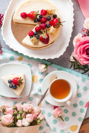 Delicious Mixed Berries Cheesecake With A Cup Of Tea Wallpaper