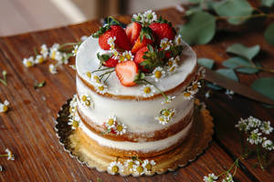 Delicious Strawberry And Flowers Decorated Cake Wallpaper