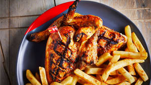 Delish Peri Peri Chicken And Fries Dish Wallpaper