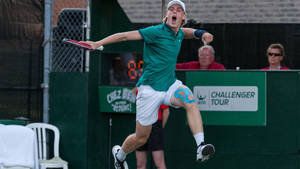 Denis Shapovalov Celebrates A Victory In Tennis Match Wallpaper