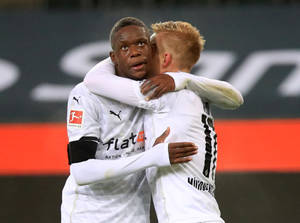 Denis Zakaria Hugging Teammate Wallpaper