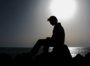 Depressed Man On Shore Line Wallpaper