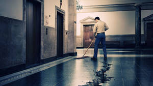 Diligent Housekeeper Performing Cleaning Services Wallpaper