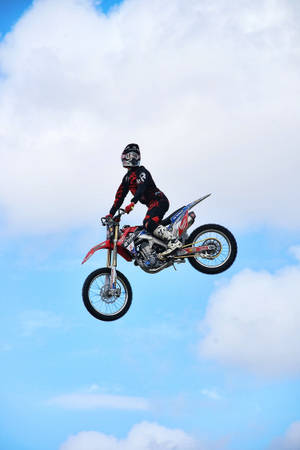 Dirt Bike Rider In Sky Wallpaper