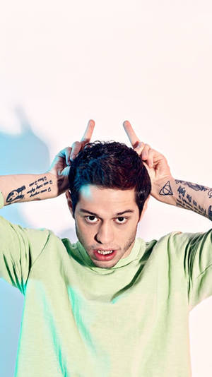 Distinctive Portrait Of Pete Davidson During A Complex Interview Wallpaper