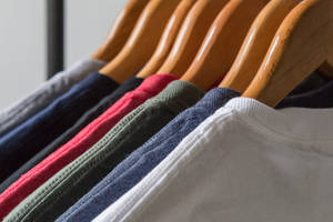 Diverse Selection Of Blank Shirts On A Rack Wallpaper