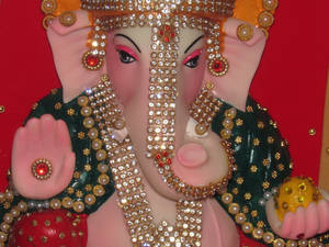 Divine Bejeweled Statue Of God Ganesh Wallpaper