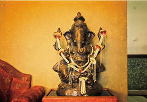 Divine Bronze Statue Of Lord Ganesh Wallpaper